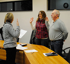 Tawas City Clerk Michelle Westcott giving the oath of office to two council members